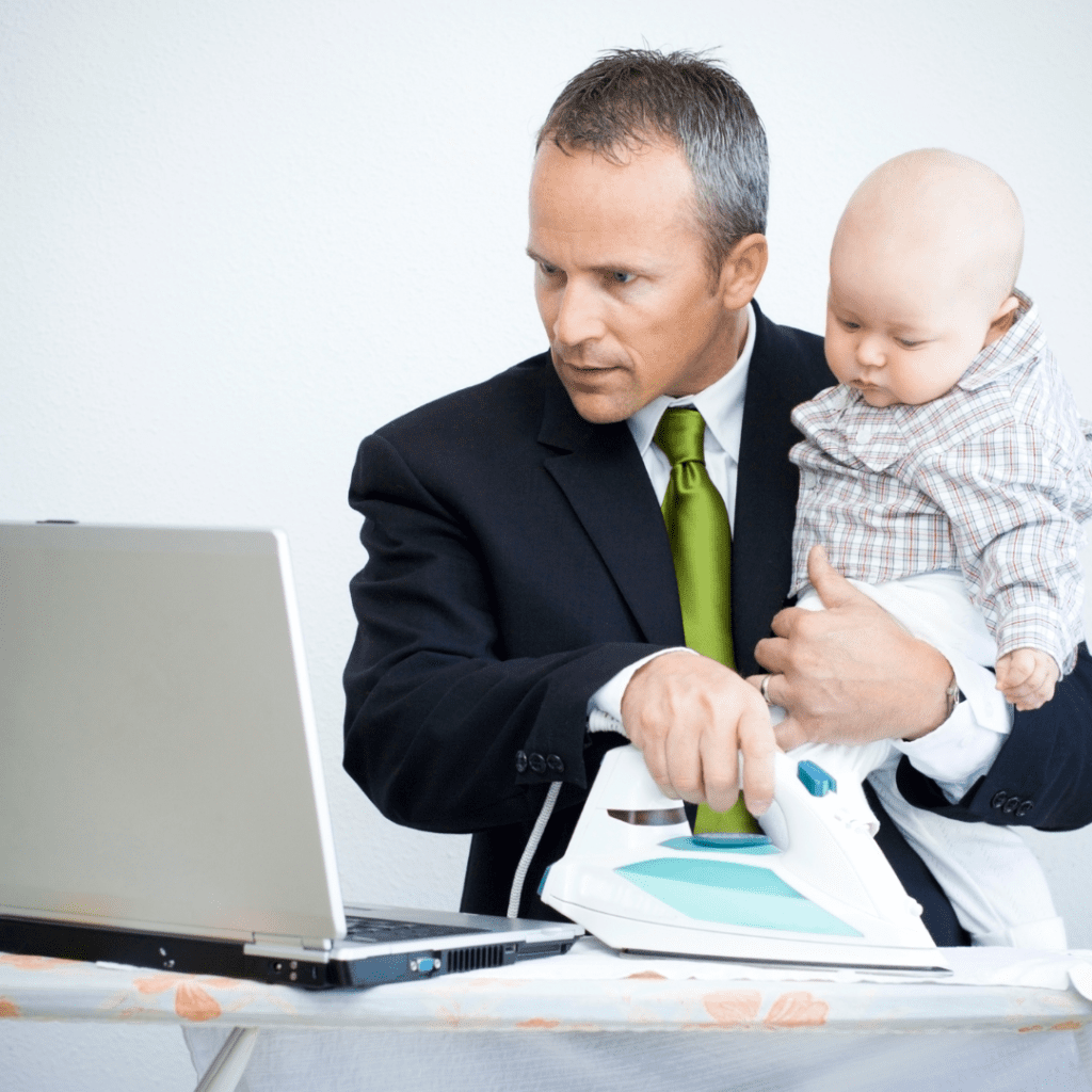 Man wfh with baby and ironing