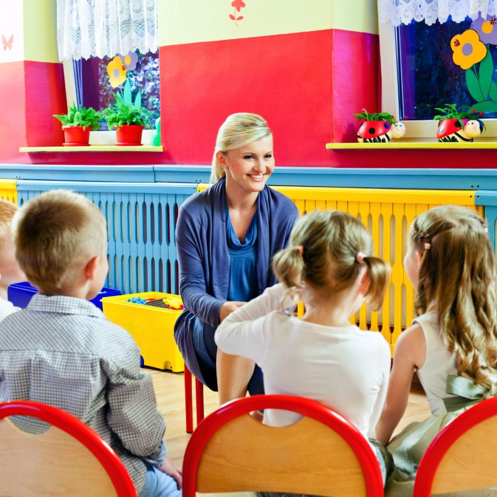 Woman working with children in a nursery